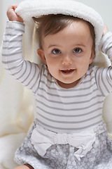 Image showing Sweet, smile and portrait of baby with a blanket for playing, sitting and having fun at home. Happy, excited and face of cute girl kid, child or toddler in a cute casual outfit in nursery at house.