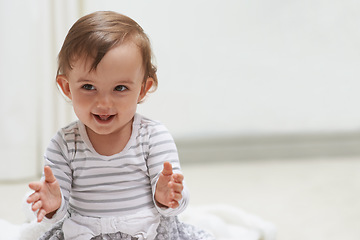 Image showing Baby, happy and playing on floor, child development and infant growth with face, sitting and home. Girl, joyful and healthy in good mood, childhood and cheerful with enthusiasm, kid and adorable