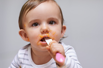 Image showing Spoon, food and baby eating in a studio for organic, healthy or nutrition vegetable meal. Sweet, cute and girl kid or toddler enjoy dinner, breakfast or lunch for child development by gray background