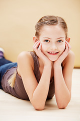 Image showing Child, portrait and smile in studio for fashion confidence on brown background as mockup space, innocence or relax. Female person, model and face of young student for positive mood, cute or style