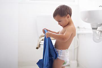 Image showing Home, morning and child dressing with clothes and learning to style or change into shirt. Kid, toddler and development of independence from self care, routine and changing into outfit or garment