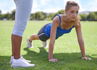 Image showing Women, coach and push ups on grass for fitness with exercise, training and workout on sports field. Athlete, person and confidence on ground and physical activity for healthy body, wellness and core