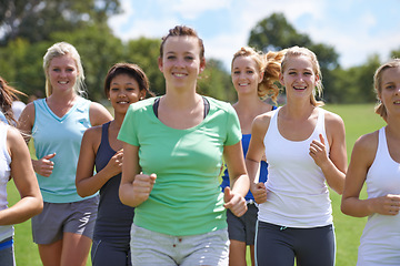 Image showing Women, fitness in group and running in park for cardio, health and wellness with training together for race. Marathon, workout and energy on sports field, runner team with smile and exercise outdoor