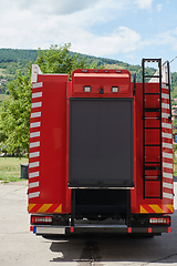 Image showing Close-up of essential firefighting equipment on a modern firetruck, showcasing tools and gear ready for emergency response to hazardous fire situations