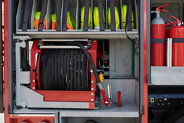 Image showing Close-up of essential firefighting equipment on a modern firetruck, showcasing tools and gear ready for emergency response to hazardous fire situations