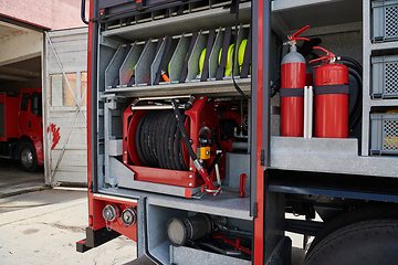 Image showing Close-up of essential firefighting equipment on a modern firetruck, showcasing tools and gear ready for emergency response to hazardous fire situations