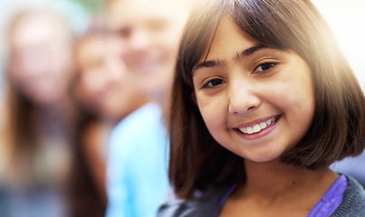 Image showing Girl, portrait and smile in corridor at school with confidence and pride for learning, education or knowledge. Student, person or face and happy in building or hallway before class and ready to study