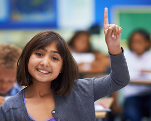 Image showing Girl, portrait and raise hand in classroom, elementary school and answer teacher question. Students, study and childhood development for education, knowledge and academic information for people