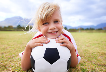 Image showing Child, soccer player and ball with portrait, smile and ready for game, field and girl. Outdoor, playful and sport for childhood, happy and athlete for match, alone and outside on football pitch