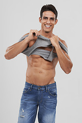 Image showing Man, portrait and dressing or bodybuilder pride in studio, happy and fitness by white background. Male person, abs and strong core or muscular abdomen, confident and results or progress from exercise