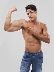 Image showing Man, portrait and biceps or bodybuilder pride in studio, wellness and fitness by gray background. Male person, arms and strong or muscular abdomen, confident and results or progress from exercise