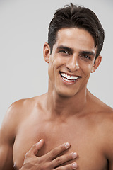 Image showing Man, shirtless and portrait or beauty in studio, smiling and joyful by gray background. Happy male person, confident and skincare or body care, face and wellness or relaxing by backdrop and treatment