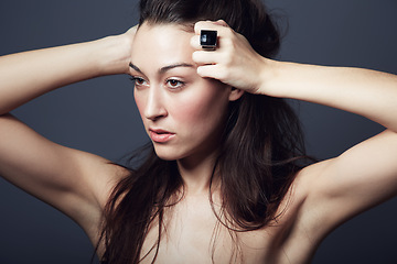 Image showing Beauty, makeup and face of woman with hair in studio, hairstyle and shine on dark background. Portrait, cosmetic care glow on skin with dermatology, haircare and texture with growth and jewellery