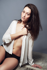 Image showing Portrait, underwear and woman in shirt for beauty in studio isolated on a gray background. Body, confidence and fashion of young female model in natural clothes or lingerie on a backdrop in Brazil