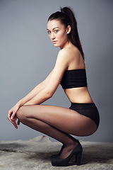 Image showing Portrait, confidence and woman in underwear kneeling in studio isolated on a gray background. Serious slim model, beauty and natural body care, health and wellness of person in Brazil for fashion