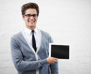 Image showing Happy man, tablet and screen for advertising or marketing against a gray studio background. Portrait of person, nerd or geek smile with technology display or mockup space for advertisement, UI or UX
