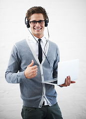 Image showing Happy man, portrait and laptop with headphones, thumbs up or winning on a gray studio background. Male person, nerd or geek smile with computer, like emoji or yes sign for good job on mockup space