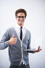 Image showing Happy man, portrait and laptop with thumbs up for winning or good job on a gray studio background. Male person, nerd or geek smile with computer, like emoji or yes sign for approval on mockup space