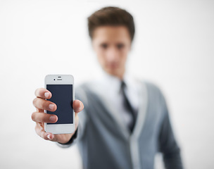 Image showing Man, hands and phone screen for advertising or marketing against a gray studio background. Closeup of male person or employee showing mobile smartphone or tech display for online app on mockup space