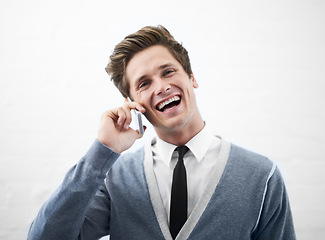 Image showing Happy man, phone call and laughing for funny joke, conversation or meme on a gray studio background. Face of young handsome person smile for fun business discussion, humor or comedy on mockup space