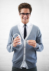 Image showing Business man, portrait and plug with cable, connection or smile for electricity by wall background. Person, employee or entrepreneur for electronics, wire or happy for power, energy and link at job