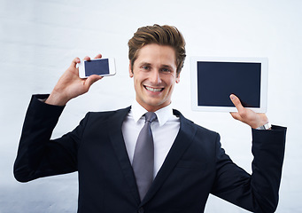 Image showing Business man, tablet and phone screen in portrait, smile and mock up space for promotion by white background. Entrepreneur, person and happy employee with blank smartphone, touchscreen and ux for app