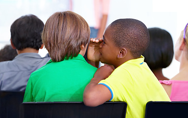 Image showing Little boys, whisper and classroom in ear for secret, gossip or communication at school. Male person, students or friends listening to rumor, information or surprise in class together with teacher