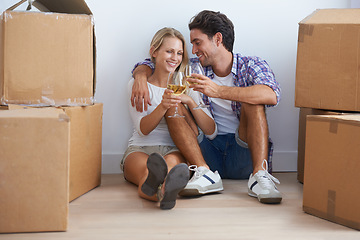 Image showing Cheers, boxes and couple with champagne in new home living room for unpacking and moving together. Happy, love and young man and woman from Australia with wine and cardboard packages in apartment.