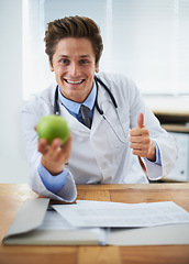 Image showing Thumbs up, apple and portrait of man doctor with stethoscope for positive, good and confident attitude. Happy, smile and young healthcare worker with fruit in medical office of hospital or clinic.
