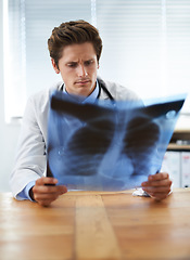 Image showing Man doctor in office and check xray, healthcare with medical diagnosis and review of lung scan at cardiology clinic. Radiology, surgeon thinking in doubt after assessment of results with MRI