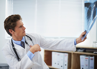 Image showing Man doctor in office, review xray and health, medical diagnosis and analysis of lung scan at cardiology clinic. Radiology, assessment of results and human anatomy with surgeon, MRI and skeleton