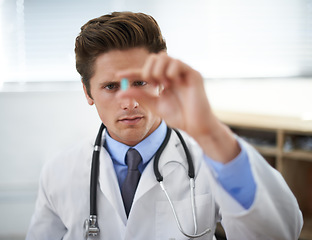 Image showing Curious man, doctor and checking pill for healthcare, cure or drugs at hospital or office. Male person, surgeon or medical nurse looking at medication in research, study or examination at clinic