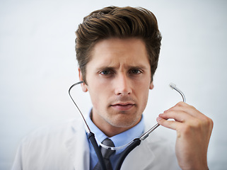 Image showing Serious, stethoscope and portrait of doctor in his office for medical concern at hospital. Doubt, thinking or worried and handsome professional male healthcare worker working at medicare clinic.