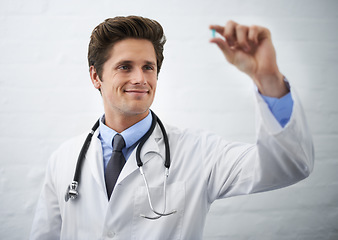 Image showing Happy man, doctor and checking pill for healthcare, cure or drugs on a white studio background or wall. Male person, surgeon or medical nurse looking at medication in research, study or examination