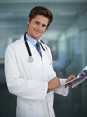 Image showing Clipboard, happy and portrait of doctor in his office for diagnosis or treatment at medical hospital. Checklist, career and professional young male healthcare worker reading in medicare clinic.