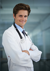 Image showing Happy, crossed arms and portrait of man doctor with stethoscope for positive, good and confident attitude. Smile, pride and young male healthcare worker in medical office of hospital or clinic.