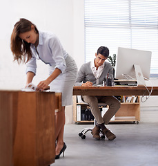 Image showing Affair, infidelity or sexual harassment with business man by desk at work, looking at bum of colleague. Computer, receptionist or temptation and young employee in office with sexy woman coworker