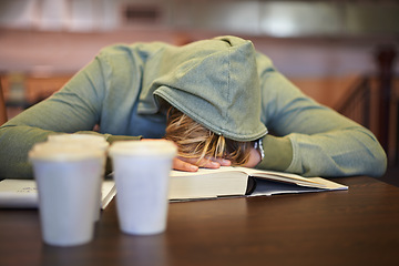 Image showing Tired, student or sleeping in library with burnout, stress depression or low energy for deadline. Fatigue, university or exhausted person with books, coffee or head down in nap on table for resting