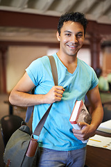 Image showing Classroom, man or college student with book, portrait or studying for knowledge, development or academy. Person, bag and learning process with smile for pride, scholarship or education for assessment