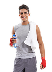 Image showing Man, martial arts and bottle in studio portrait for fitness, health and contact sport by white background. Person, athlete and smile on face with water, pride and exercise for mma, fight and conflict