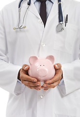 Image showing Doctor, man and piggy bank for savings in studio, investment and financial loan for healthcare. Male professional, funding and planning hospital budget by white background, profit and future security