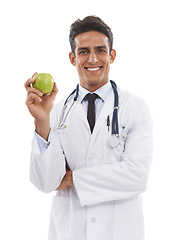 Image showing Doctor, portrait and man smile with apple in studio, nutrition and healthy diet or fiber in fruit. Male medical professional, healthcare and promotion of organic snack, face and white background
