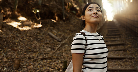 Image showing Nature, travel and Japanese woman in park for adventure on holiday, vacation and morning in woods. Thinking, happy and person in forest, path and trail to explore, walking and freedom in Kyoto