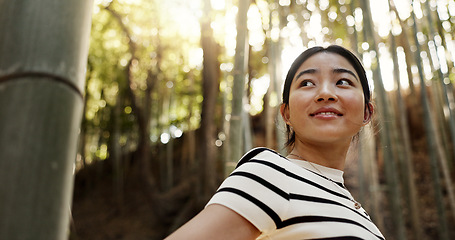 Image showing Happy, bamboo and Japanese woman in forest for adventure on holiday, vacation and morning in woods. Travel, nature and person with natural plants in woods for explore, walking and freedom in Kyoto