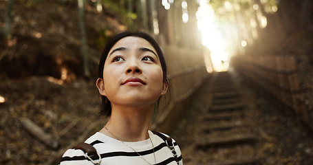 Image showing Nature, thinking and Japanese woman in forest for adventure on holiday, vacation and morning. Travel, relaxing and person with natural plants in woods for freedom, walking and explore in Kyoto