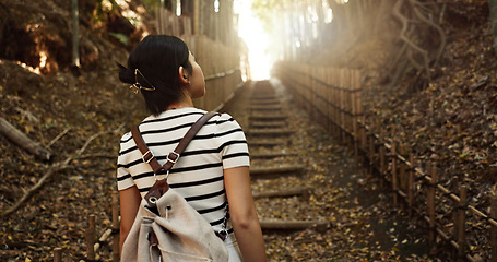 Image showing Nature, travel and back of Japanese woman in park for adventure on holiday, vacation and morning in woods. Relax, happy and person in forest, path and trail to explore, walking and freedom in Kyoto