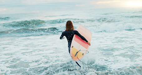 Image showing Surfing, beach and woman in water for surfboard for sports, fitness and freedom by ocean. Nature, travel and back of person running in sea for wellness on holiday, vacation and adventure for hobby