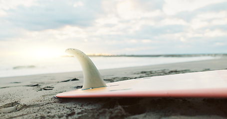 Image showing Beach, sand and surfboard at ocean water in the background on summer vacation, travel or holiday in Japan. Sea, surf and sports in nature outdoor for adventure, action or recreation on a landscape