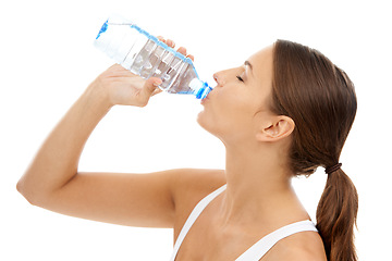 Image showing Fitness, woman and drinking water in studio for exercise break, energy and healthy detox on white background. Thirsty model, liquid hydration and bottle for sports nutrition, weight loss diet or care