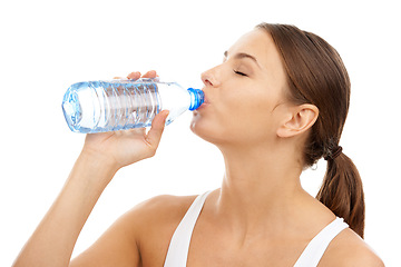 Image showing Exercise, woman and drinking water in studio for sports break, energy and detox for healthy recovery on white background. Athlete, hydration and bottle of liquid for nutrition, fitness diet or thirst